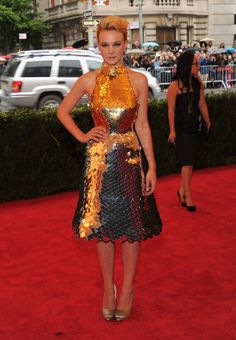 a woman standing on top of a red carpet