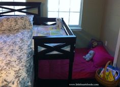 a small child's crib in the corner of a room next to a window