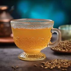 a glass cup filled with liquid next to grains