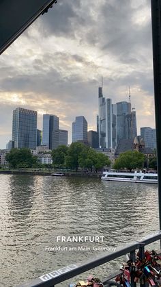 a bridge with padlocks on it and the city in the background