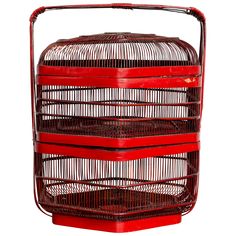 a red birdcage with three sections stacked on top