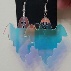 Acyrlic iredescent ghost earrings. Perfect for spooky season!  Approx size is 3.5cm x 4.5cm  Earring hooks are 925 sterling silver,  so they're great for allergies or sensitive ears! please note that shipping doesn't come with tracking  you can find my other listings here: https://grumpyqueer.etsy.com Spooky Earrings, Iridescent Earrings, Ghost Earrings, Ghost Halloween, Earrings Cute, Halloween Earrings, Hypoallergenic Earrings, Acrylic Earrings, Cute Earrings