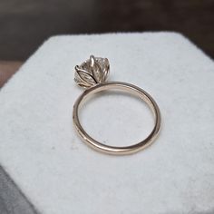 a diamond ring sitting on top of a white piece of paper that has been placed on it