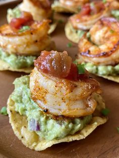 shrimp and guacamole on tortilla shells with avocado garnish