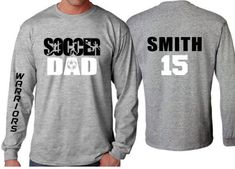 Soccer Dad Shirt | Soccer Long sleeve (one sleeve/one word only) Shirt | Customize your team & colors PLEASE READ BEFORE ORDERING WE CANNOT RUSH ORDERS OR CREATE NEW DESIGNS DURING PEAK SEASON AUG - MAY. IF YOU NEED TO CANCEL PLEASE DO SO WITHIN 24HRS Please read full description before ordering we cannot be responsible for mistakes made by not reading the full description. ORDERING INSTRUCTIONS: 1. Select your Garment Size/Color Each size must be selected separately. Please do NOT leave a l Athletic Heather Long Sleeve T-shirt With Letter Print, Long Sleeve T-shirt With Team Name For Sports Season, Sports Fan Long Sleeve T-shirt With Letter Print, Cotton Long Sleeve Sublimation T-shirt For Sports Events, Long Sleeve Tops With Team Name For Sports Events, Sports Event Long Sleeve Tops With Team Name, Long Sleeve T-shirt With Letter Print For Team Events, Long Sleeve Sports Event Tops With Team Name, Long Sleeve Sports Fan T-shirt For Sports Season