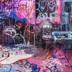 a bathroom with graffiti all over the walls