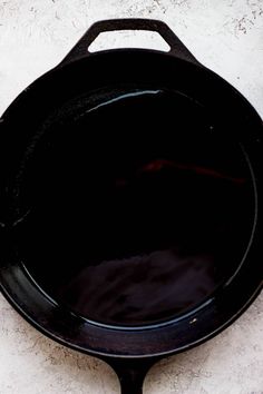 a black frying pan sitting on top of a white counter