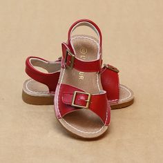 Elegant stitch down leather sandal with buckled strap - a wonderfully crafted classic style in pretty colors. This versatile sandal works for day trips and school and pairs well with sweet dresses and chic shorts. Leather upper Leather lining & sock Stitch down construction Padded collar Open toe cut out strap Hidden velcro fastening under buckle accent Rubber outsole Toddler sizes 5-13; Youth sizes 1-2. Size Chart (in-sock length, measured from inside): Size 5 6 7 8 9 10 In. 5.5 5.8 6.1 6.4 6.7 Chic Shorts, Sweet Dresses, Toe Loop Sandals, Pretty Colors, Classic Kids, Sweet Dress, Childrens Shoes, Toddler Sizes, Pretty Colours