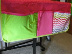 a baby crib that has some colorful fabric on it