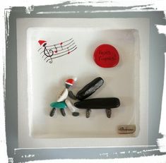 a couple of figurines sitting on top of a white box with musical notes