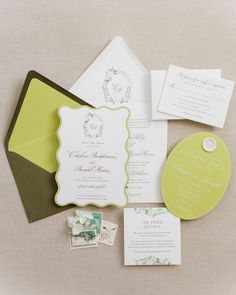 the wedding stationery is laid out on top of each other, including an envelope and some cards