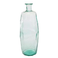 a green glass vase sitting on top of a white table