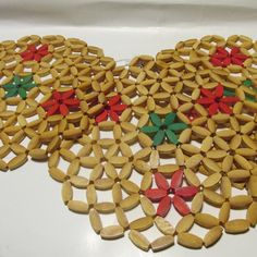 two pieces of wood are arranged in the shape of christmas wreaths with red, green and yellow bows