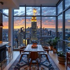 a dining room table with chairs and a rug in front of large windows overlooking the city