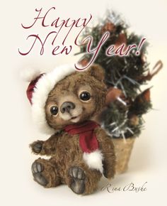 a brown teddy bear sitting next to a small christmas tree with the words happy new year written on it