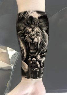 a man's leg with a tattoo on it and an image of a lion