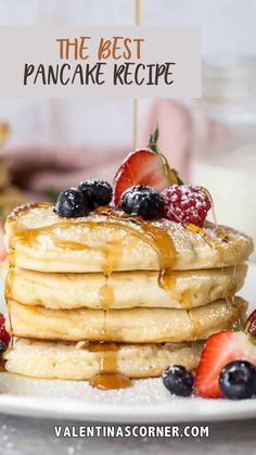 the best pancake recipe with fresh berries and syrup is on top of a white plate