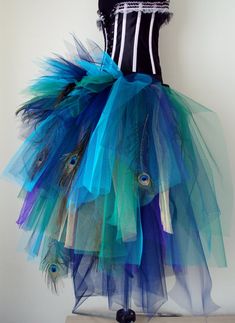 a dress made out of tulle with peacock feathers on the bottom and black top