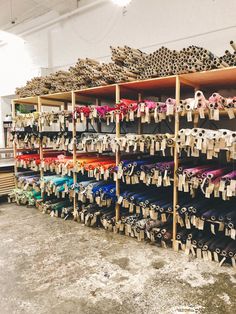 many pairs of shoes are lined up on shelves