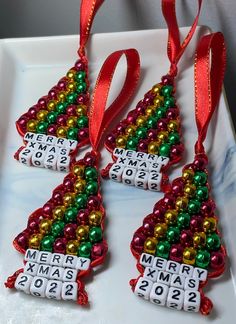 three christmas tree ornaments are on a plate