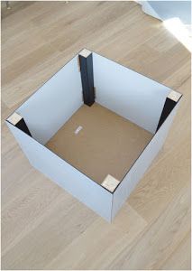 an open box sitting on top of a hard wood floor