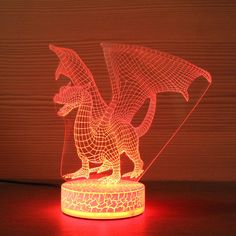 an illuminated dragon sculpture on a wooden table