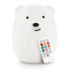 a white bear with a remote control in it's mouth, on a white background