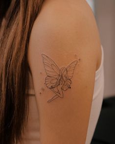 a woman's arm with a tattoo on it that has a fairy tinkerbell