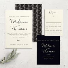 the wedding stationery is laid out on top of each other, including an elegant black and white design