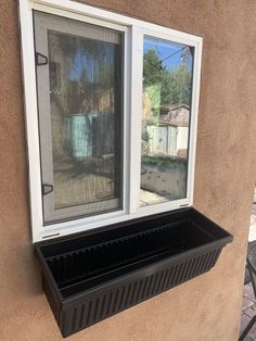 a window that is open on the side of a building