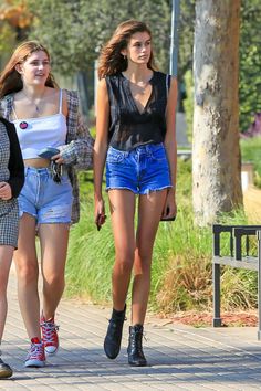 two young women walking down the street together