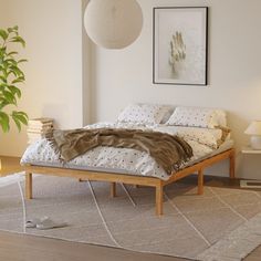 a bedroom with a bed, lamp and pictures on the wall above it is shown