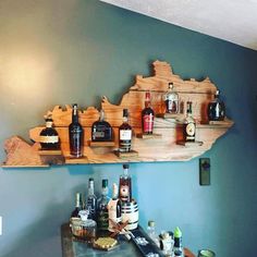 a wooden shelf filled with liquor bottles on top of a wall