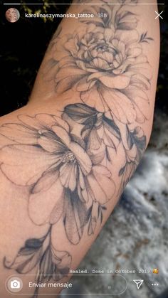 a woman's arm with flowers on it