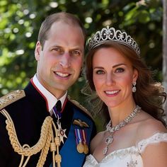 a man and woman in wedding attire posing for a photo with their tiara on