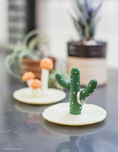 two small cactus figurines sitting on top of a table