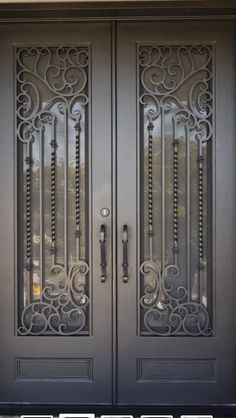 two double doors with decorative iron work on the sides and side panels that are painted black