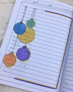 an open notebook with colored balls on it