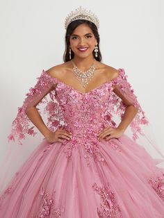 You'll love twirling around in this 3D floral applique long off the shoulder cape dress with A-line skirt by House of Wu 26052. Off-the-shoulder neckline with sequin lace appliqués and sparkle tulle ball gown skirt. Has a lace-up back and train. The detachable cape is included - giving you a versatile second look! House of Wu Quinceanera Collection Spring 2023 Style Number: 26052 Fabric: Tulle/Sequin Lace Appliques/3D Floral Appliques Please note: There may be a loss of glitter while wearing thi