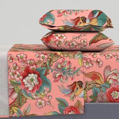 three pink boxes with floral designs on them