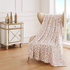 a leopard print blanket draped over a chair