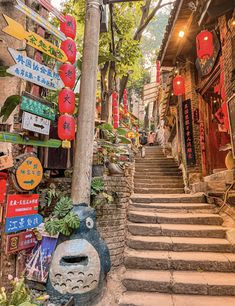 an alleyway with stairs and signs on it