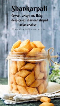 a glass jar filled with cookies sitting on top of a table