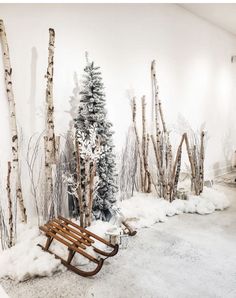 there is a bench in front of the snow - covered trees that are on display