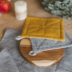 a wooden cutting board topped with a yellow cloth