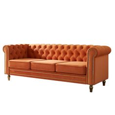 an orange couch sitting on top of a white floor