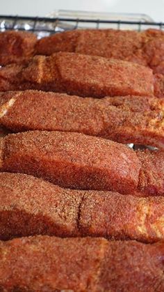 some meat is sitting on a cooling rack and ready to be cooked in the oven