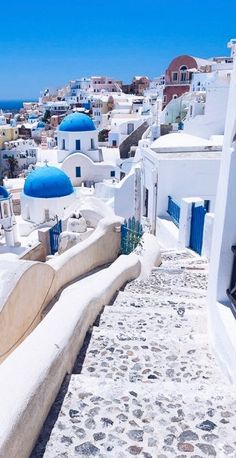 a bench sitting on the side of a building next to a blue and white dome