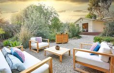 an outdoor living area with couches and chairs