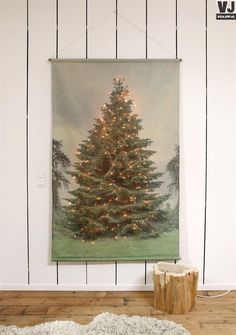 a christmas tree is hanging on the wall next to a white rug and wooden floor